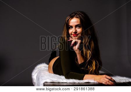 Beautiful Dancer. Girl Model. The Girl Sits In A Hat And Sits On A Table. Girl In A Beautiful Underw