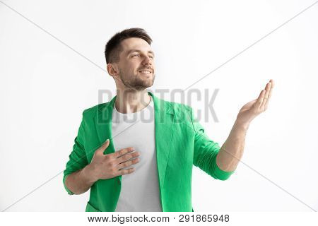 Looking For The Best Moment. Young Dreaming Smiling Man Is Waiting For Chanses Isolated On Gray Back