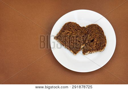 Sliced Rye Bread On The White Plare And Brown Background. Whole Grain Rye Bread With Seeds