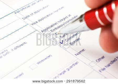 Schengen Visa, Questionnaire. Hand With Pen Completing A Questionary