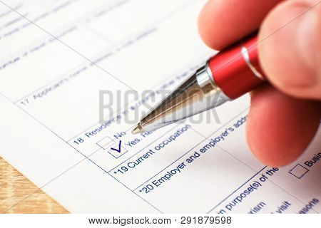 Schengen Visa, Questionnaire. Hand With Pen Completing A Questionary
