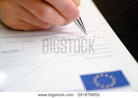 Schengen Visa, Questionnaire. Hand With Pen Completing A Questionary