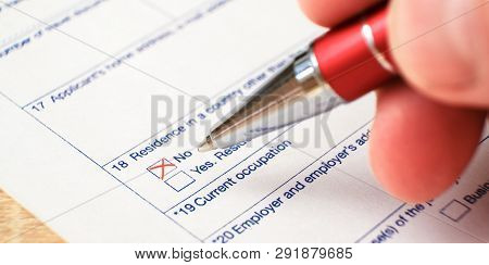 Schengen Visa, Questionnaire. Hand With Pen Completing A Questionary