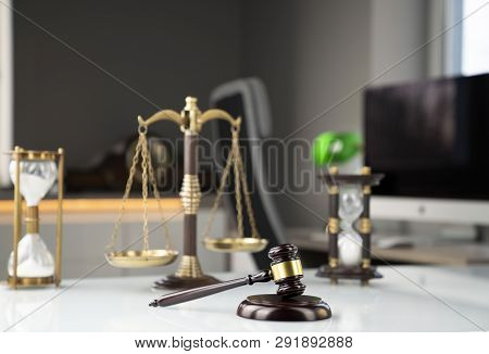 Legal Office Concept. Gavel, Computer, Scale And Hourglass On The White Table.