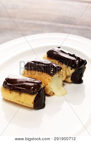 Traditional French Dessert. Eclair With Chocolate Icing. Pastery Concept With Chocolate Eclair
