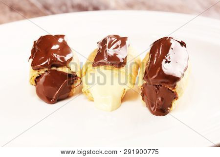 Traditional French Dessert. Eclair With Chocolate Icing. Pastery Concept With Chocolate Eclair