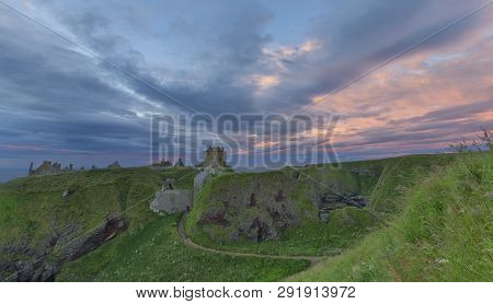 Landscape Of Dunnottar Castle Ruins Withh Dark Clouds And The Ocean
