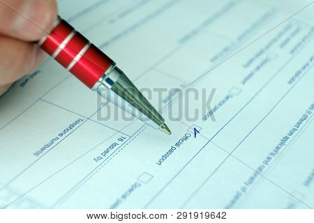 Schengen Visa, Questionnaire. Hand With Pen Completing A Questionary