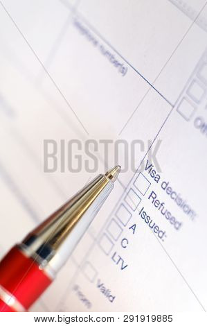 Schengen Visa, Questionnaire. Hand With Pen Completing A Questionary