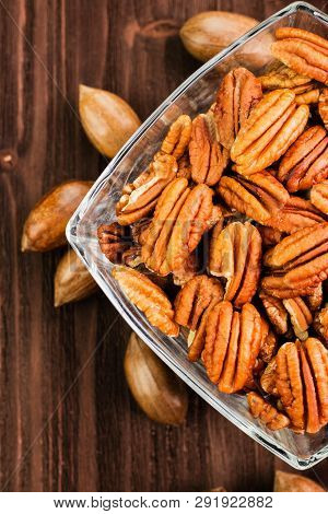 Pecan Nuts In The Shell With Pecan Kernel On Wooden Background