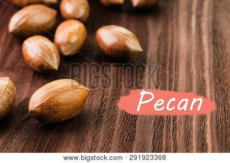 Pecan Nuts In The Shell On Wooden Background