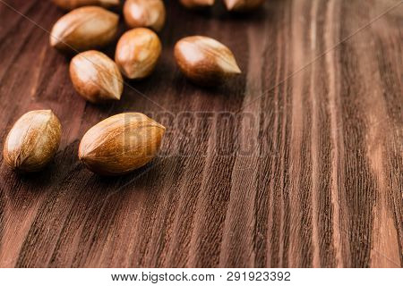 Pecan Nuts In The Shell On Wooden Background