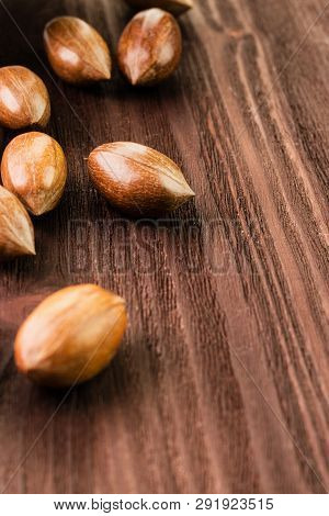 Pecan Nuts In The Shell On Wooden Background