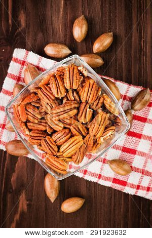 Pecan Nuts In The Shell With Pecan Kernel On Wooden Background