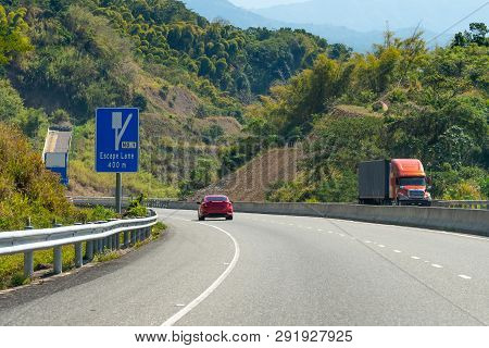 Escape Lane Ahead On Highway Through Mountains On Caribbean Island
