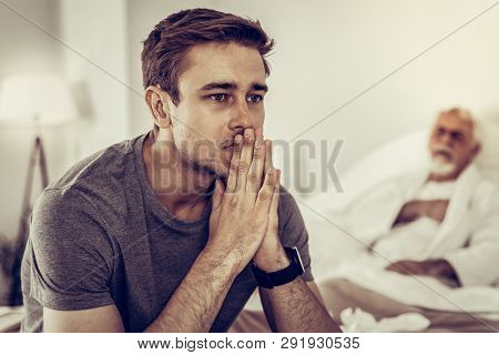 Portrait Of Man Worrying About The Health Disorder Of Dad