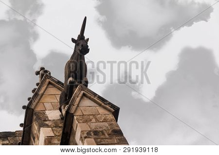 Low-angle View Of The Sculpture Of Unicorn On The Facade Of The Cathedral Of The Holy Cross And Sain