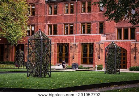 Toronto, Canada - 20 10 2018: A Student Sitting Beside The Entrance Of The Munk School Of Global Aff