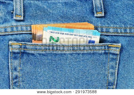 Several Bills Of Fifty And Twenty Euros In The Back Pocket Of Jeans. Concept Of Absentminded Person,