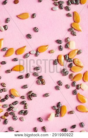 Healthy superfood:  flax seeds, chia seeds and hemp shelled seed on pink background