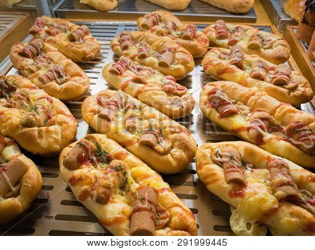 Grill Sausage Bread With Tomato And Cheese Souce. Sousages Boat Snack On Display At Bread Store
