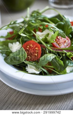 Fresh Salad With Aragula And Tomato In A Plate