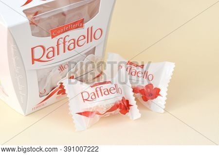 Raffaello Candies On Beige Background. Raffaello Is A Spherical Coconut Almond Confection That Itali