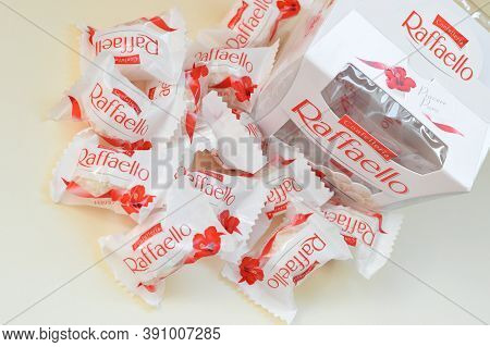 Raffaello Candies On Beige Background. Raffaello Is A Spherical Coconut Almond Confection That Itali