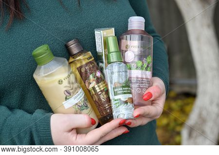 Young Girl Holds Yves Rocher Production In Bottles. Yves Rocher Is A Worldwide Cosmetics And Beauty 