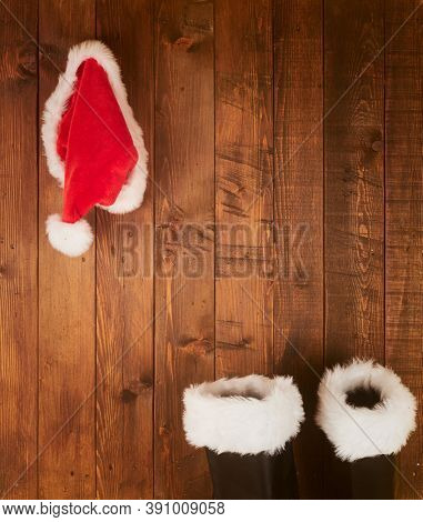 Santa Claus boots and hat  hanging on Wood wall