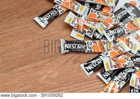 Many Nescafe Caramel Cream Coffee Sticks On Wooden Background. Nescafe Is A Brand Of Coffee Made By 