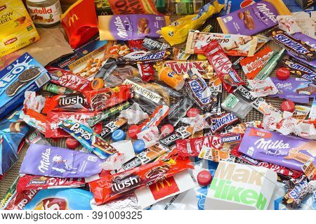 Many Wrappings And Cans From Used Products By Famous Worldwide Brands. Pattern Of Trash Of Various C