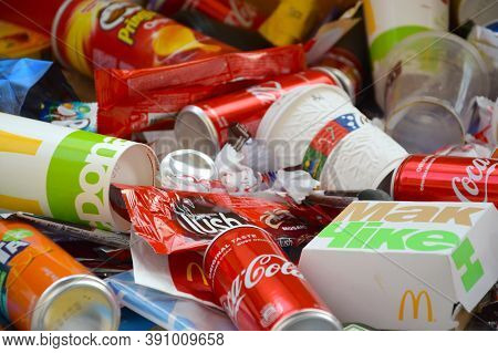 Many Wrappings And Cans From Used Products By Famous Worldwide Brands. Pattern Of Trash Of Various C