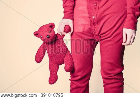 teddy bear hanging from a red figure