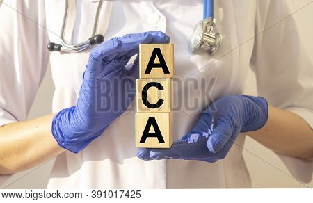 Aca Or Affordable Care Act Text Acronym On Cube Blocks In Doctor Hands In Gloves