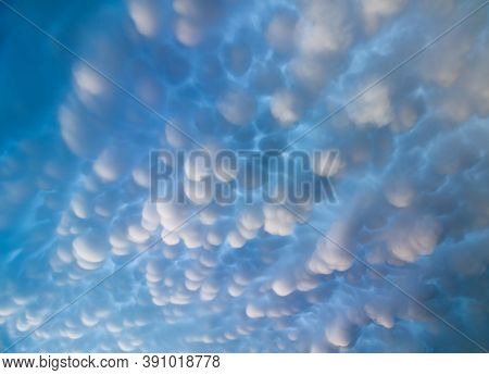 A Mesmerizing Display Of Mammatus Clouds Fills The Sky Above.