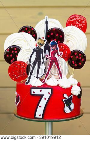 Minsk, Belarus, 08.08.2020: Red Cake With Lady Bug And Supercat For Childs Birthday With Number 7, I