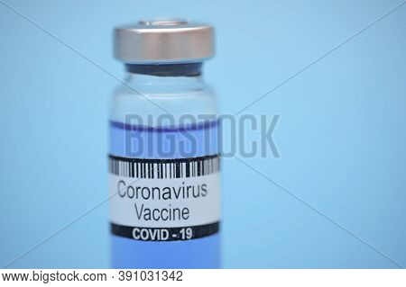 Coronavirus Vaccine In Bottle On Blue Background With Space For Text. Victory Over Corona Virus Sars