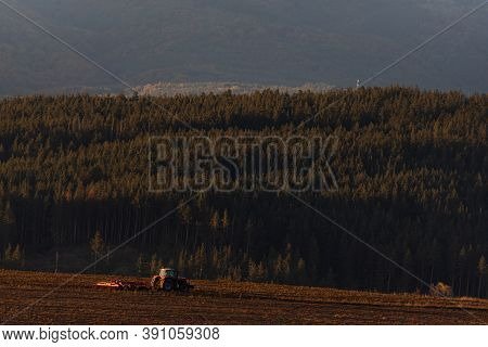 Tractor Moving Hay Field On Dark Wood And Mountain Background Forest Scenery Bulgaria Rural Copy Spa