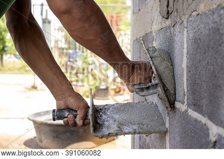 Close-up Of Workers Using Plaster Trowel To Plaster The Walls For House Construction, Working Ideas 