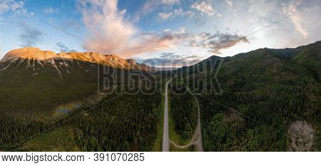 Picturesque Panoramic View Of Scenic Highway Surrounded By Golden Rocky Mountains At Sunset In Canad