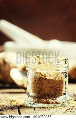 Ground Ginger In A Glass Jar And Fresh Ginger Root, Vintage Wooden Background, Selective Focus