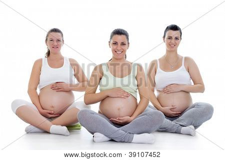 Group of smiling pregnant women doing prenatal yoga