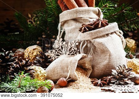 Christmas Atmosphere: Spices, Candies, Cones And Nuts With Fir Paws On A Vintage Wooden Background, 