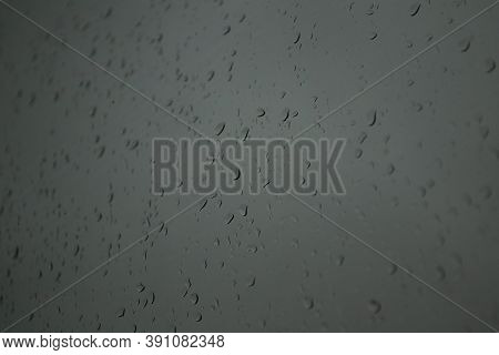 Drops Of Autumn Rain On The Glass On A Cloudy Day.
