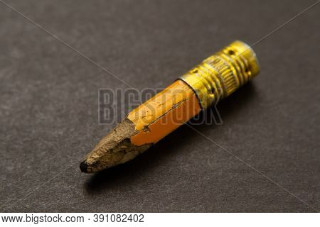 A Small Remnant Of A Yellow Pencil On The Table.