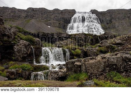 Majestic Dynjandi (fjallfoss) Waterfall With A Cascade Of Smaller Falls In Iceland During Cloudy Wea