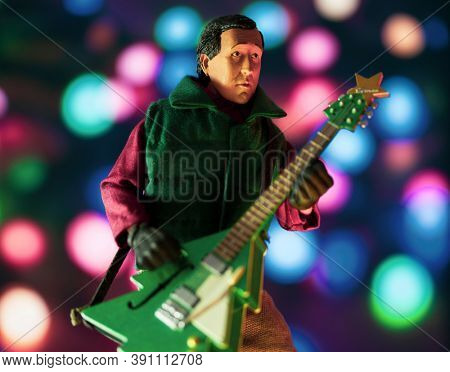 OCT 17 2020 - National Lampoon's Christmas Vacation Clark Griswold with a Christmas Tree guitar and light background - Neca action figure