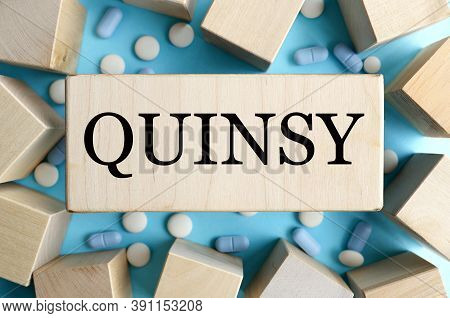 Quinsy, Text On Wood Block, Blue Background