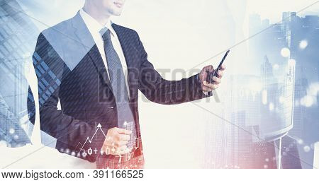 Unrecognizable Young Businessman Standing With Smartphone In Blurry City. Concept Of Corporate Lifes